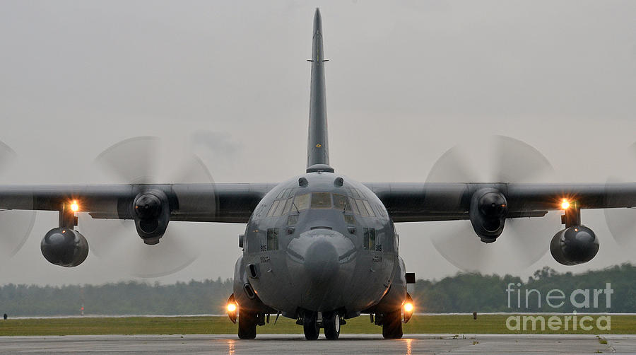 A C-130 Hercules taxis on the flight line Photograph by Celestial Images