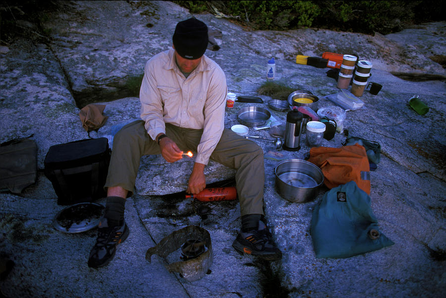 Sunset Photograph - A Camper Lights A Stove To Cook Dinner by David McLain
