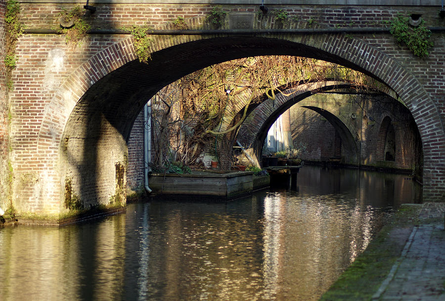 A canal in Utrecht under the bridges Photograph by Jolly Van der Velden