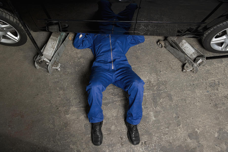 A car mechanic servicing a car Photograph by Andreas Schlegel