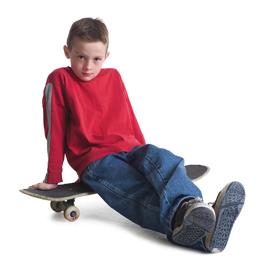 A Caucasian Boy In Jeans And A Red Sweater Sits On His Skateboard And Smiles Slightly Photograph by Photodisc