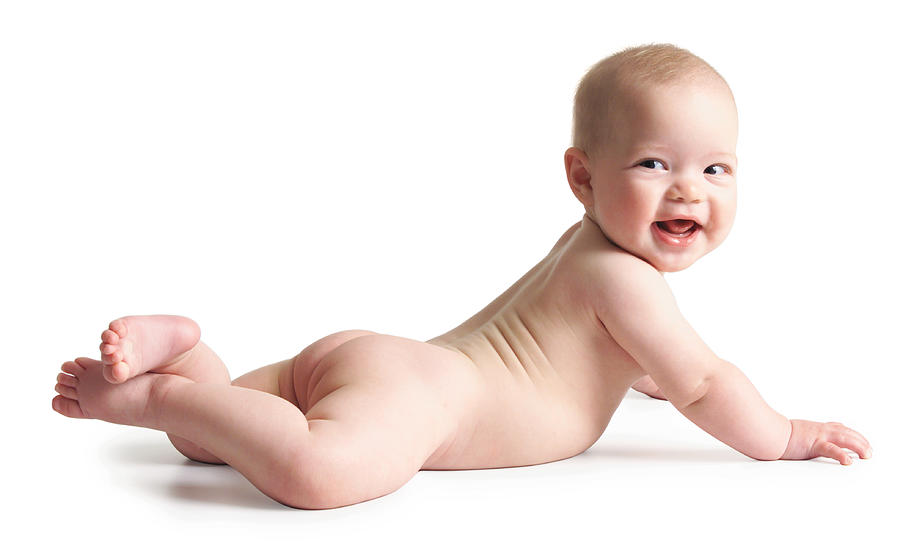 A Caucasian Naked Baby Lies On Its Stomach As It Turns And Smiles Photograph by Photodisc