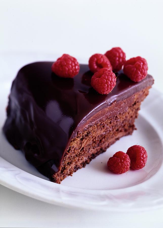 A Chocolate Pecan Cake With Raspberries On Top Photograph by Romulo Yanes