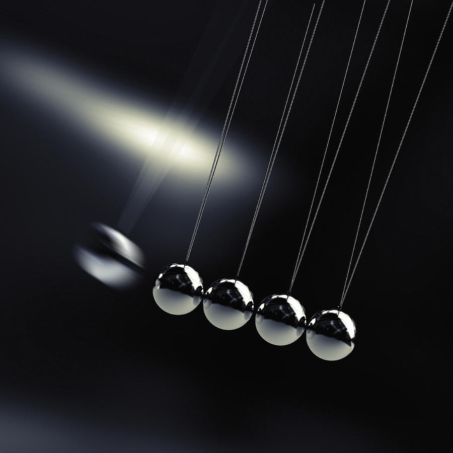 A chrome ball on a newtons cradle swinging to hit Drawing by Doug Armand