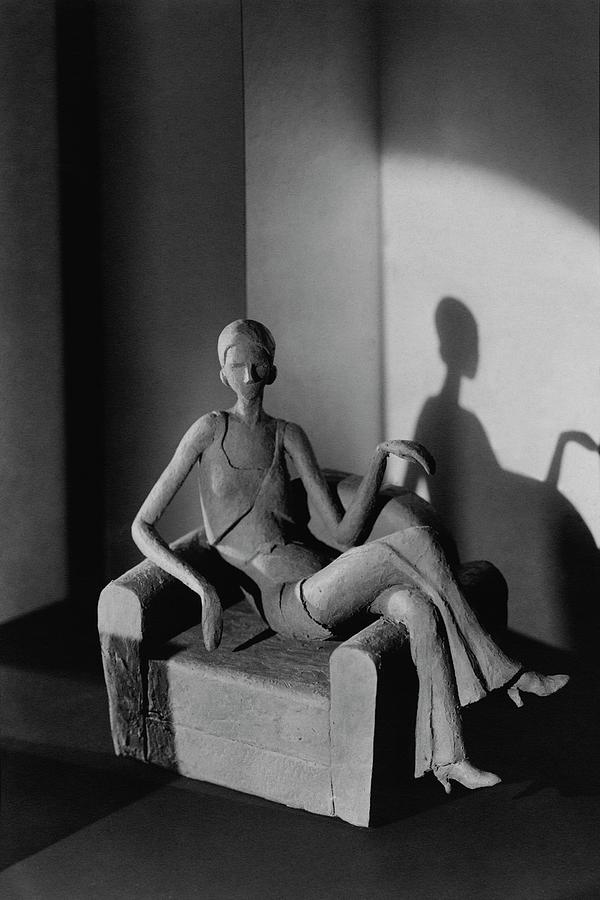 A Clay Figure Sitting On A Chair Photograph by  Barnaba