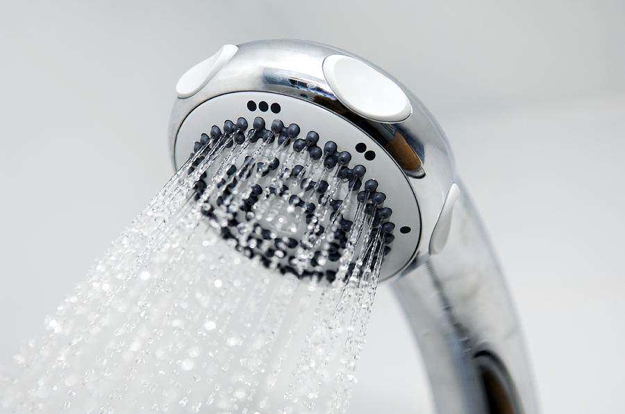 A close-up of a silver chrome shower head spouting water Photograph by DaveBolton A close-up of a silver chrome shower head spouting water Photograph by DaveBolton