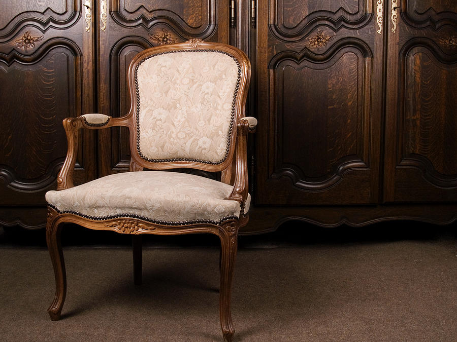 A close-up of an antique cream colored armchair Photograph by Krysteq