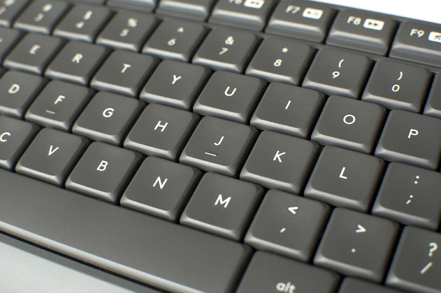 A close up picture of a gray keyboard Photograph by Karl Tapales