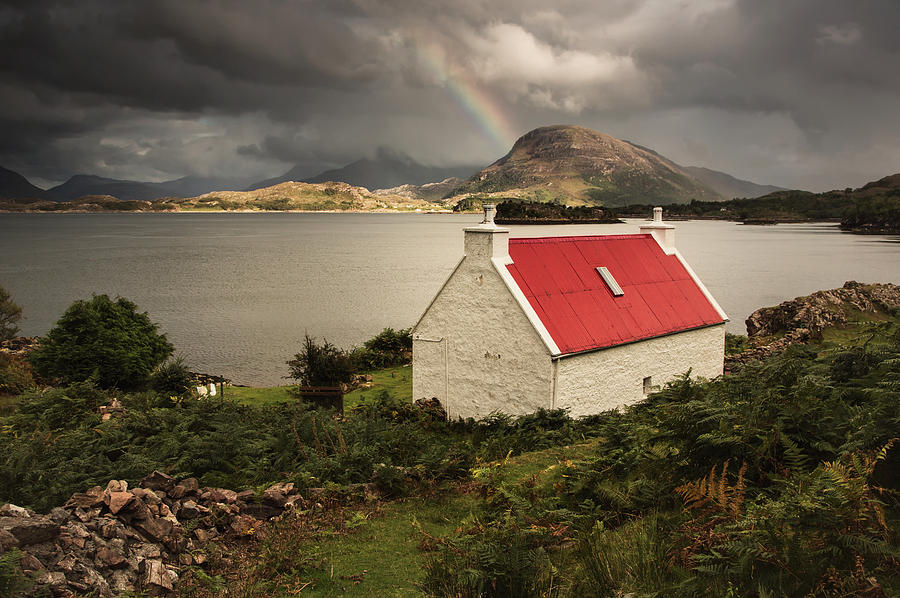 A Cottage With A Red Roof On The Water Photograph by John Short