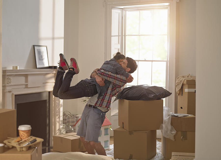 A couple celebrating moving in to a new home Photograph by 10000 Hours