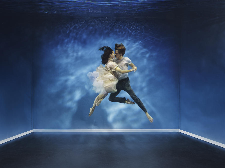 A couple dancing under water Photograph by Henrik Sorensen