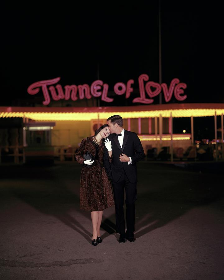 A Couple In Front Of A Tunnel Of Love Photograph by Jerry Schatzberg