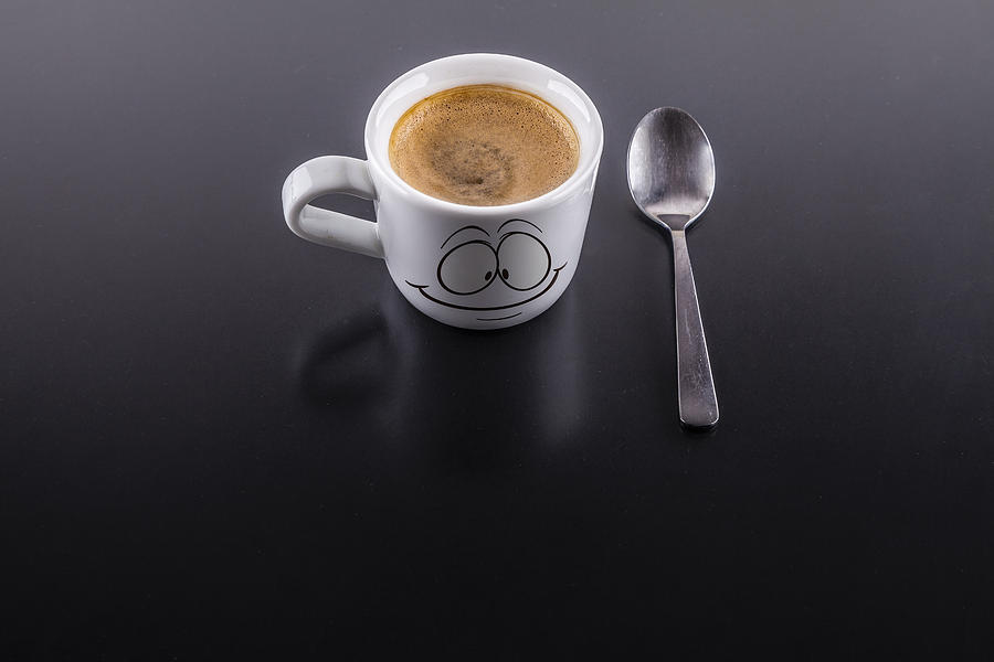 A cup of coffe with a spoon Photograph by Mjrodafotografia