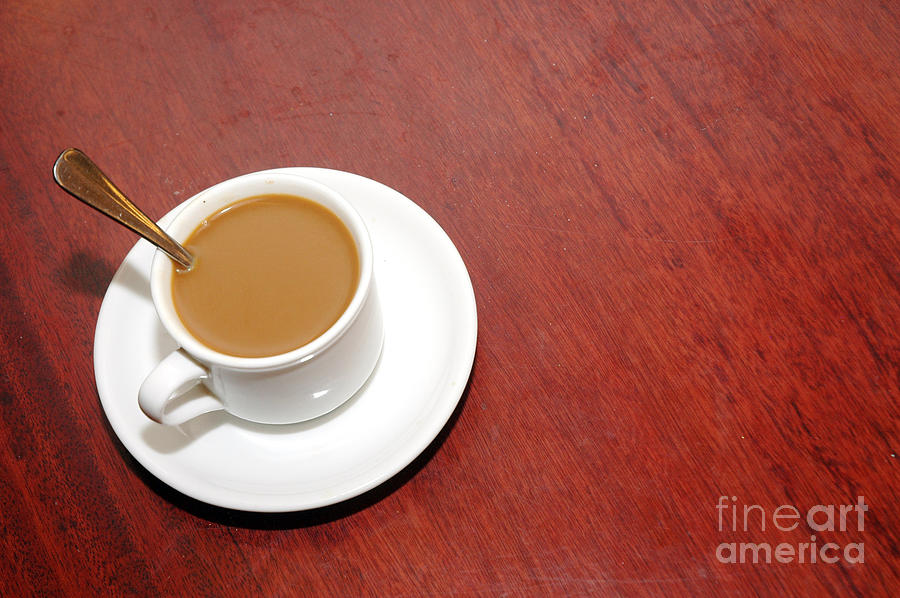 A Cup Of Coffee With Creamer Photograph