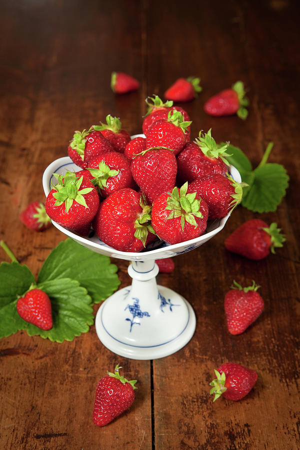 A Dish Of Fresh Strawberries On A Photograph by Ursula Alter