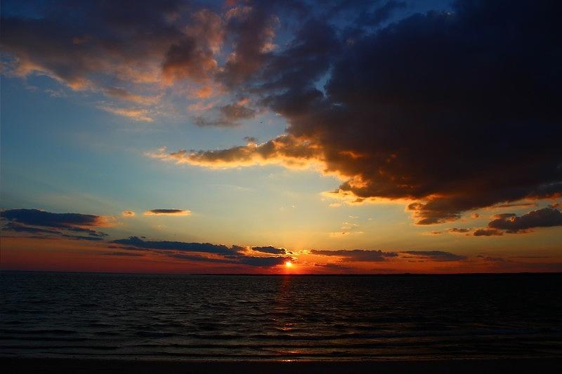 Sunset Photograph - A Distant Sun by Jennifer Leuzze