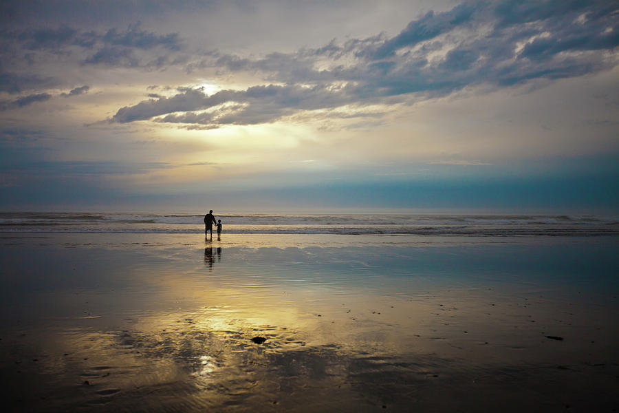 Sunset Photograph - A Father And Son Watch The Sunset While by Christopher Kimmel