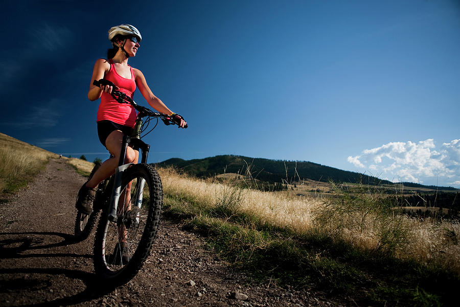 A Female Mountain Biker Stops To Enjoy Photograph by Jared Alden - Fine ...