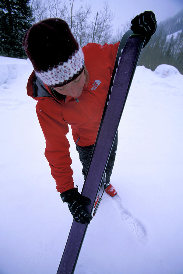 A Female Telemark Skier Puts Skins Photograph by Corey Rich - Fine Art ...