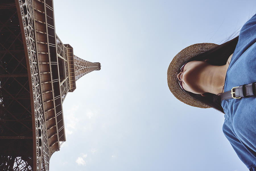 a female tourist under Eiffel Tower Photograph by Fancy.yan
