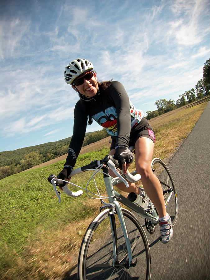 A Fit Female Cyclist Rides Her Road Photograph by Chris Bennett | Fine ...