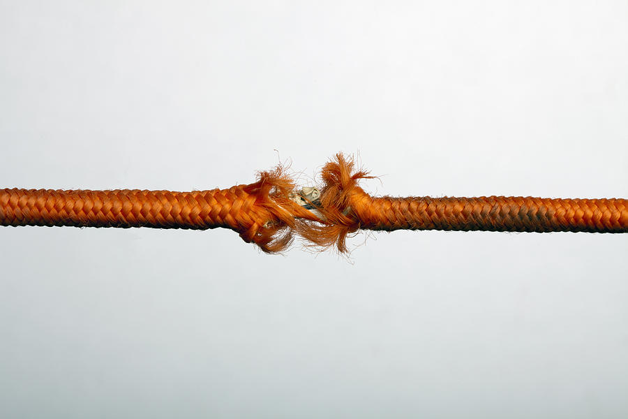 A fraying orange rope Photograph by Larry Washburn