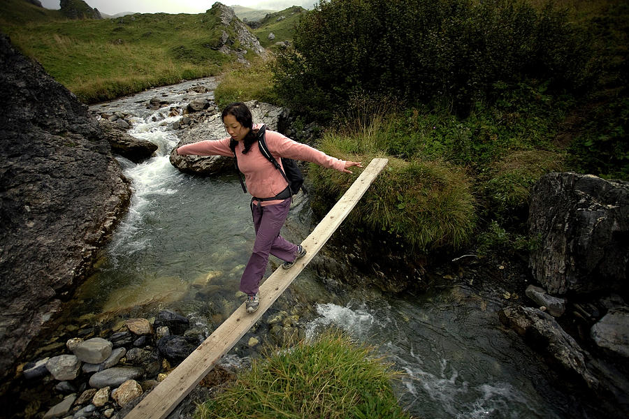 Nature Photograph - A Girl Crossing A Bridge Over A Stream by Olivier Renck