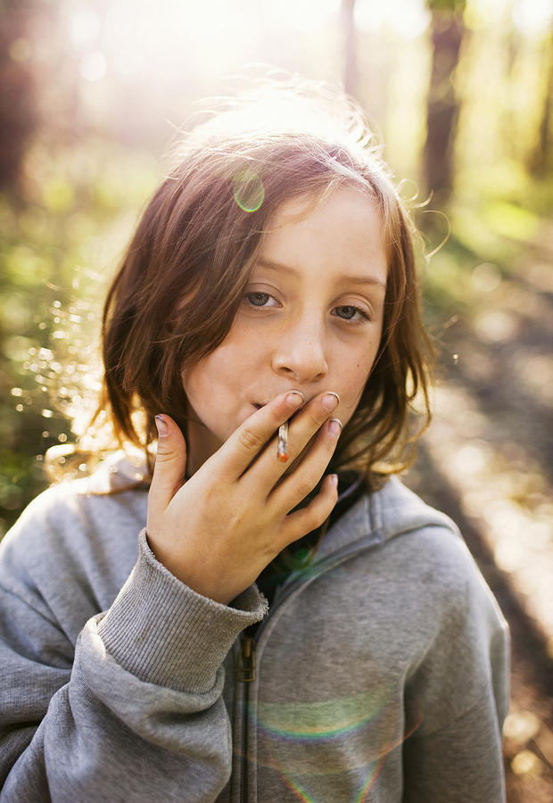 A girl pretending to smoke Sweden. Photograph by Susanne Walstrom