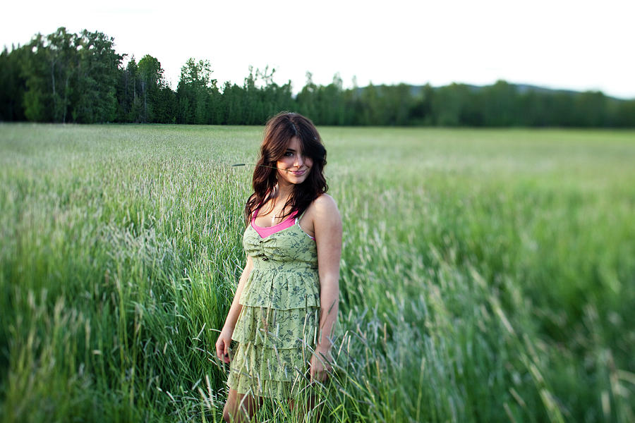 Nature Photograph - A Girl Stands In A Grassy Field by Patrick Orton