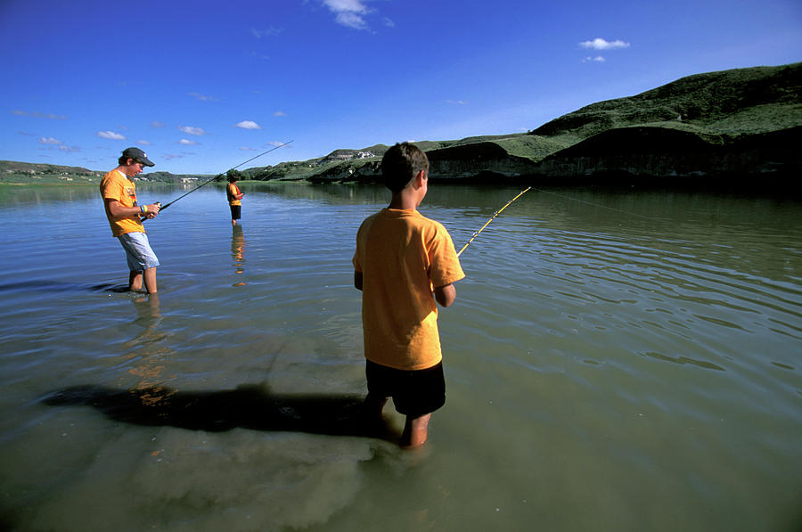 A Group Of Boys Fishing In A River Photograph by Corey Rich - Fine