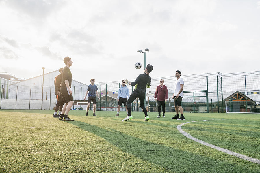 A group of mates playing keepy-uppy Photograph by JohnnyGreig