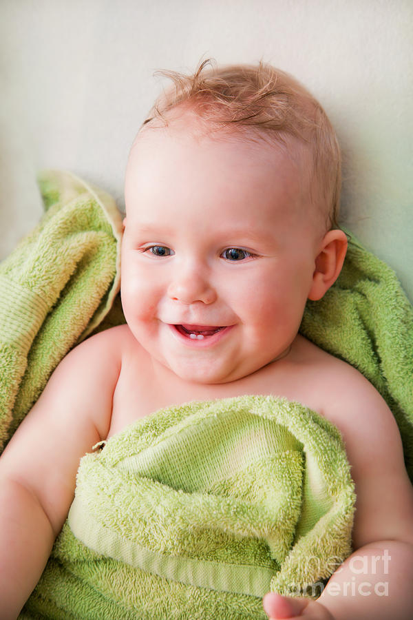 A happy baby lying on bed in green towel Photograph by Michal Bednarek ...