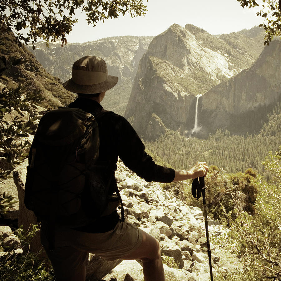 Yosemite National Park Photograph - A Hiker Looks Off In The Distance by Ron Koeberer