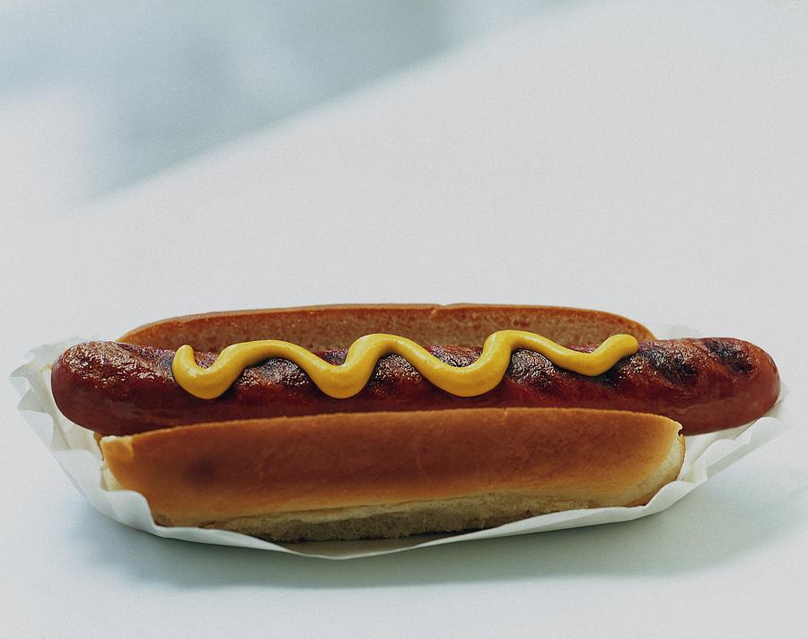 A Hot Dog With Mustard Photograph by Romulo Yanes
