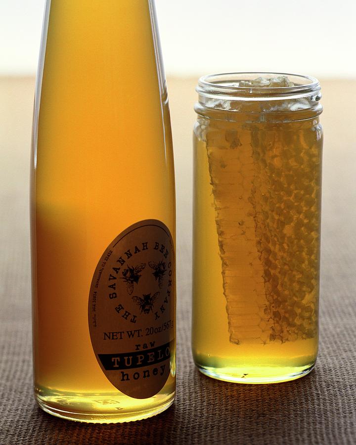 A Jar And Bottle Of Honey Photograph by Romulo Yanes