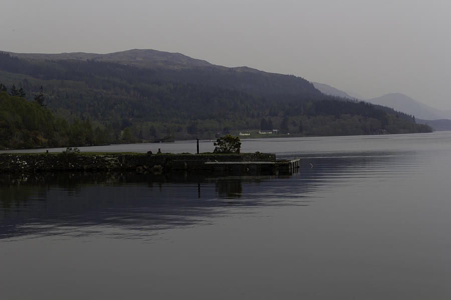 A jetty pushing out into the waters of Loch Ness in Scotland Photograph by Ashish Agarwal