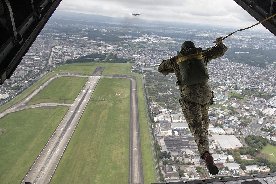 A jump from C-130 Hercules Photograph by Celestial Images