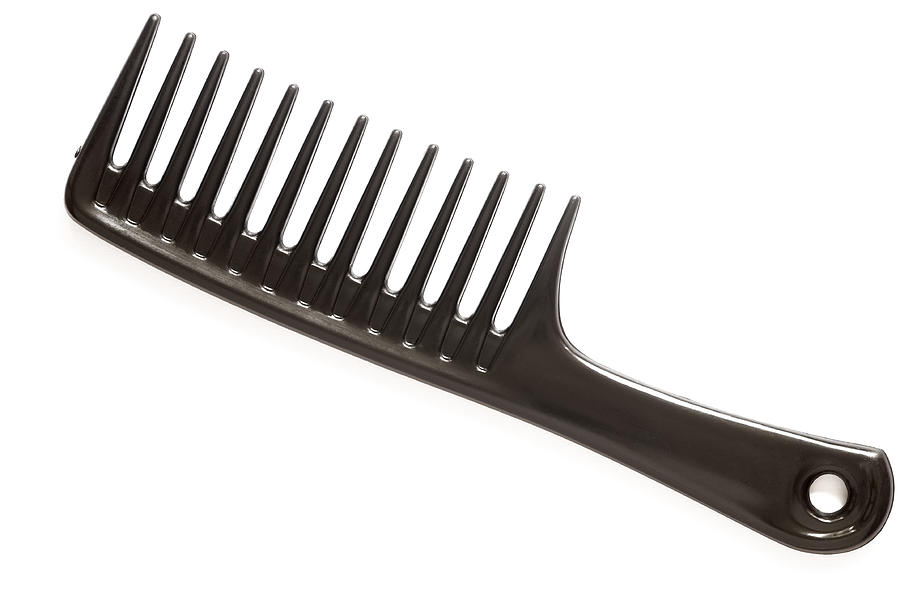 A large black comb on a white background Photograph by Onebluelight