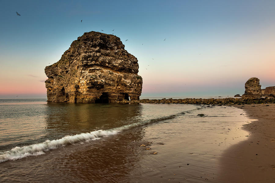 A Large Rock Formation On The Coast Photograph by John Short