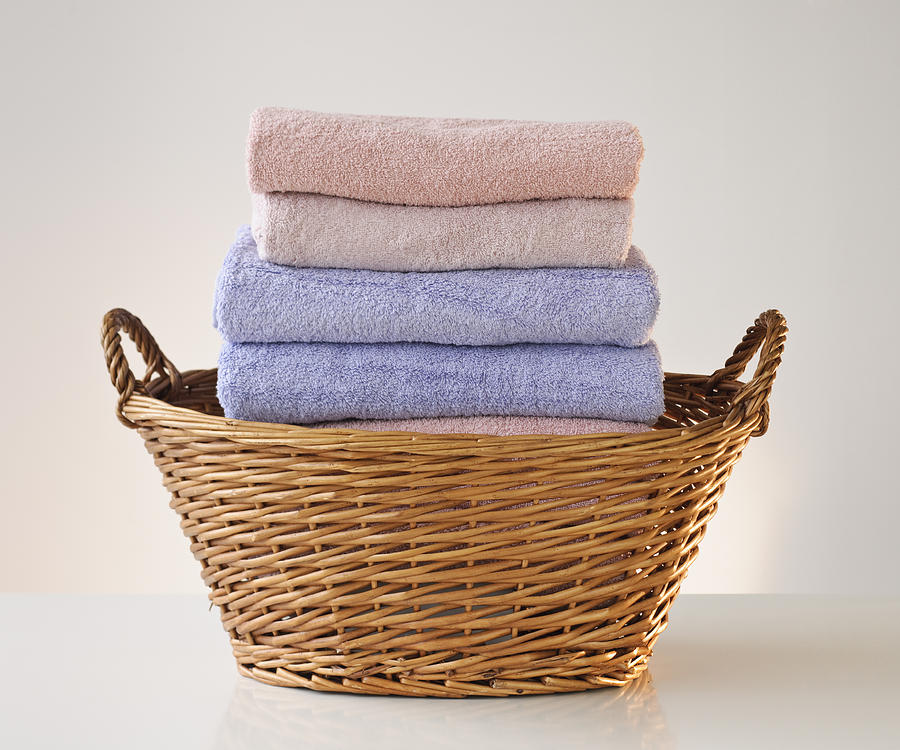 A laundry basket full of towels Photograph by Tetra Images