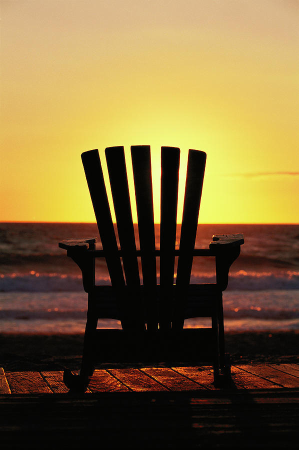 A Lawn Chair On A Beach At Sunset Photograph by Steve Winter