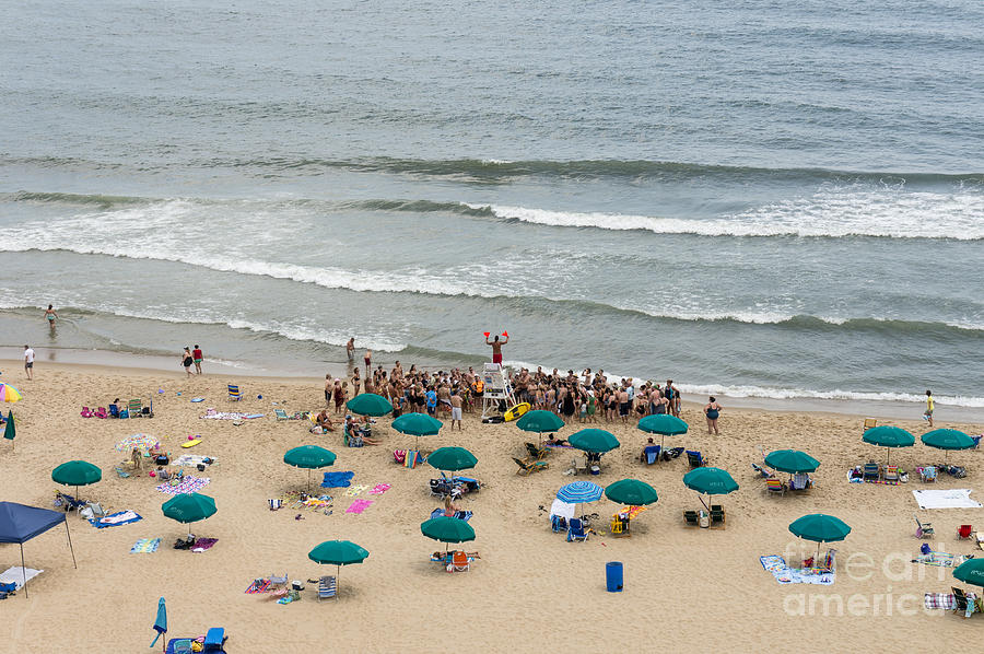 A lifeguard gives a safety briefing to beachgoers in Ocean City Maryland Photograph by William Kuta