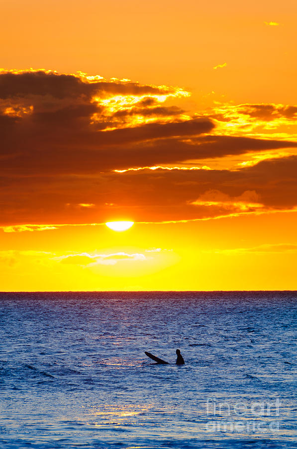 A lone surfer at sunset Maui Hawaii USA Photograph by Don Landwehrle