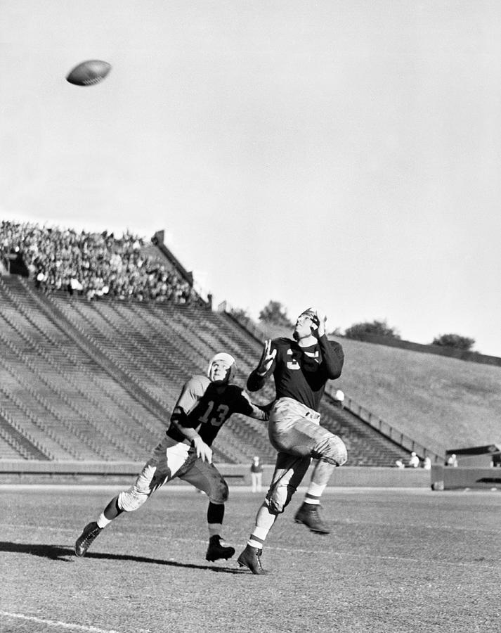 Black And White Photograph - A Long Football Pass by Underwood Archives