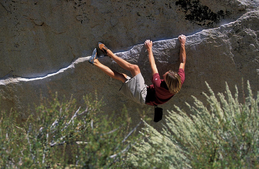 A Male Rock Climber Heel Hooking While Photograph By Corey Rich Fine Art America