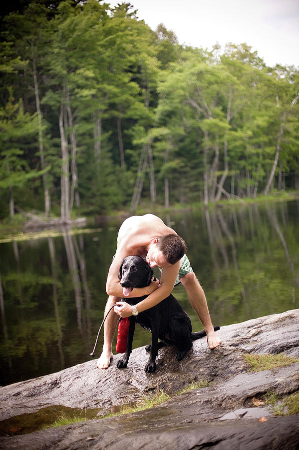 Summer Photograph - A Man And His Dog Play Next To A Lake by Christopher Cumming