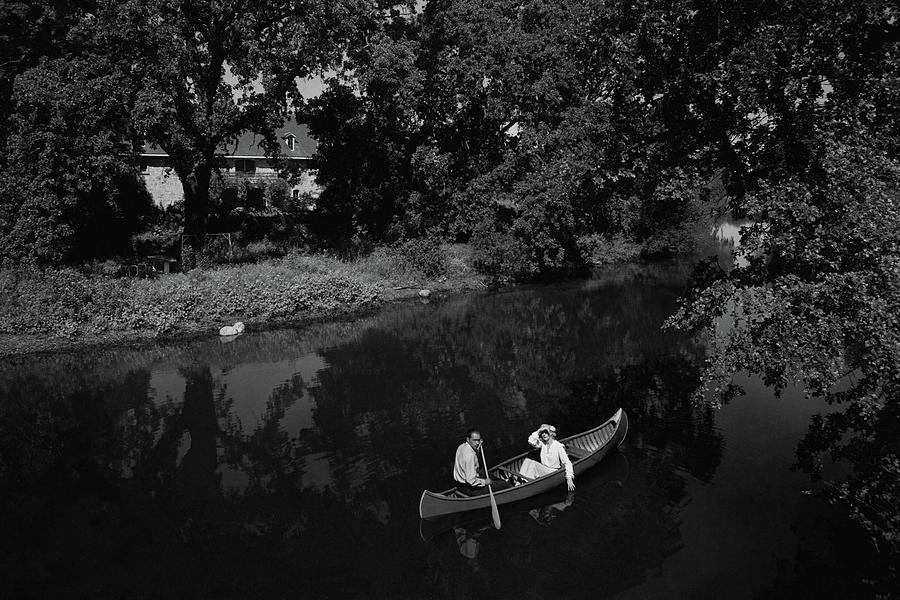 A Man And Woman In A Canoe On A Lake Photograph by Roger Sturtevant