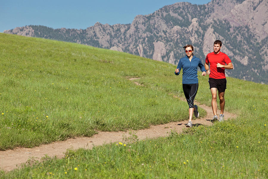 A Man And Woman Run On A Grassy Trail Photograph by Rich Crowder - Fine ...