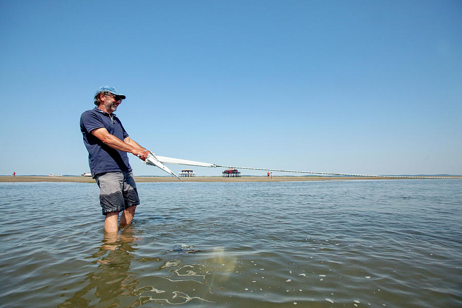 A Man Dropping The Anchor By Low Tide Photograph by Christophe Launay ...