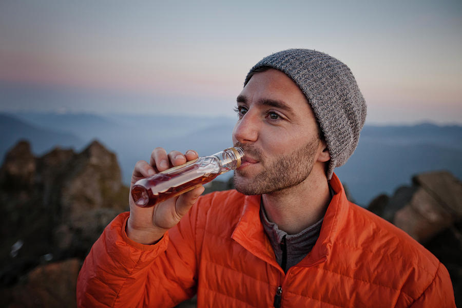 A Man Enjoys A Swig Of Whiskey Photograph by Christopher Kimmel